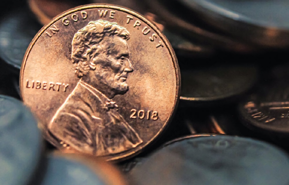 Close up of a penny in a bed of coins.
