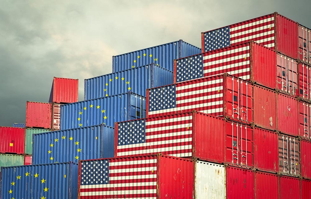 Stacks of shipping containers stylized with American and European Union flags.
