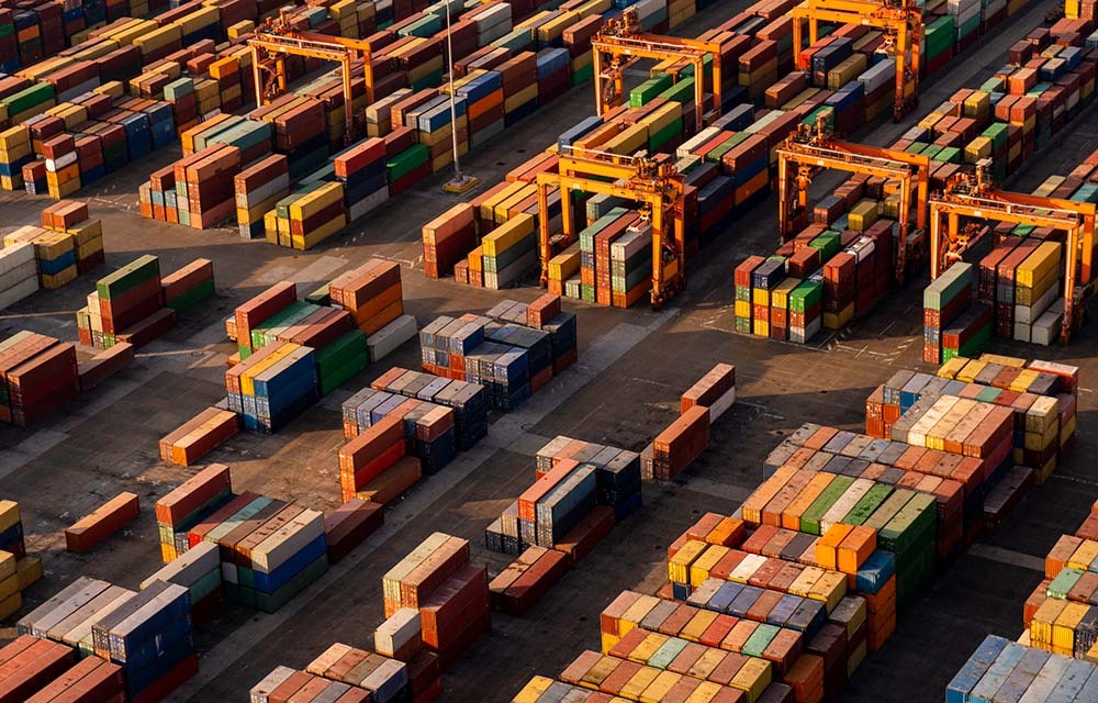 Rows of shipping containers stacked and awaiting shipment.
