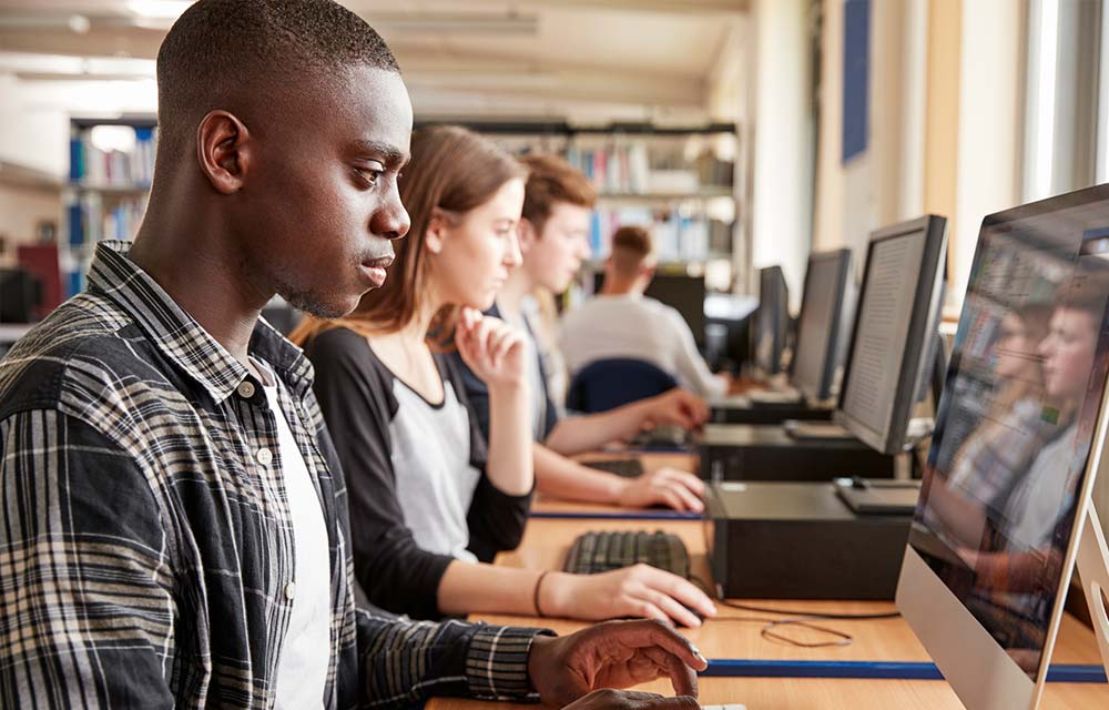 photo of college students using computers