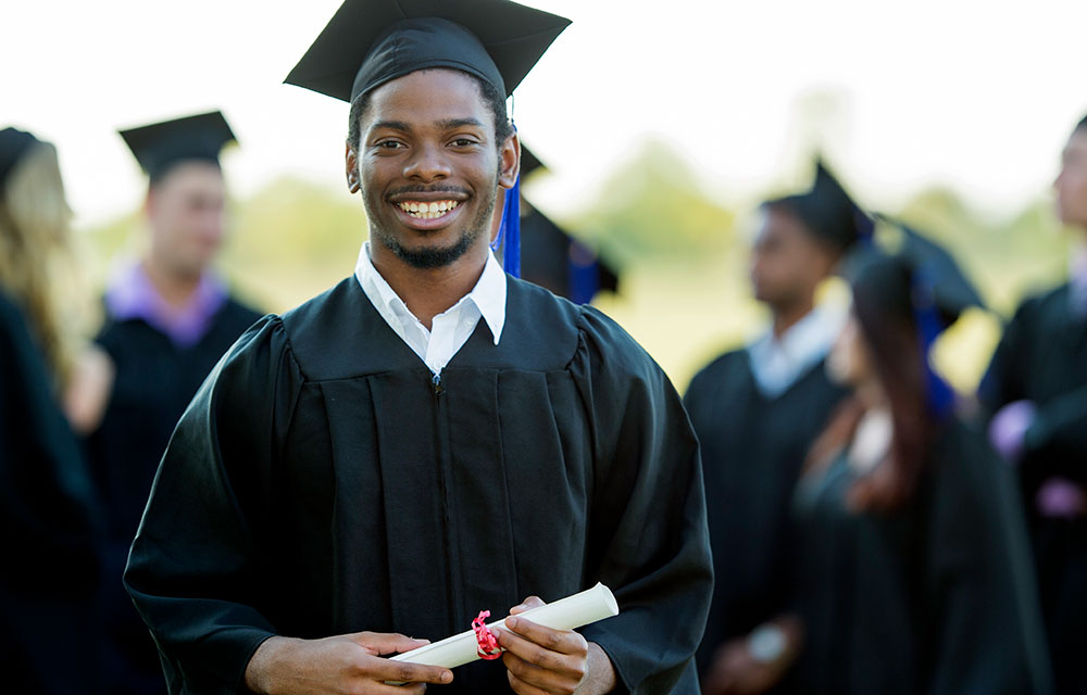 A happy graduate holding his diploma