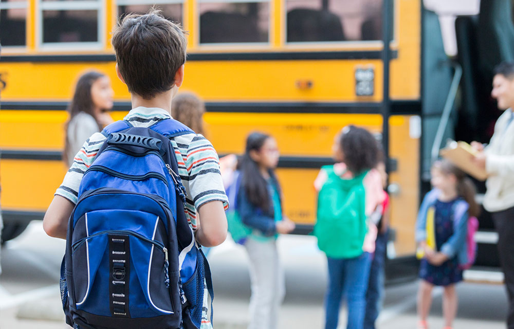 kids getting on a school bus