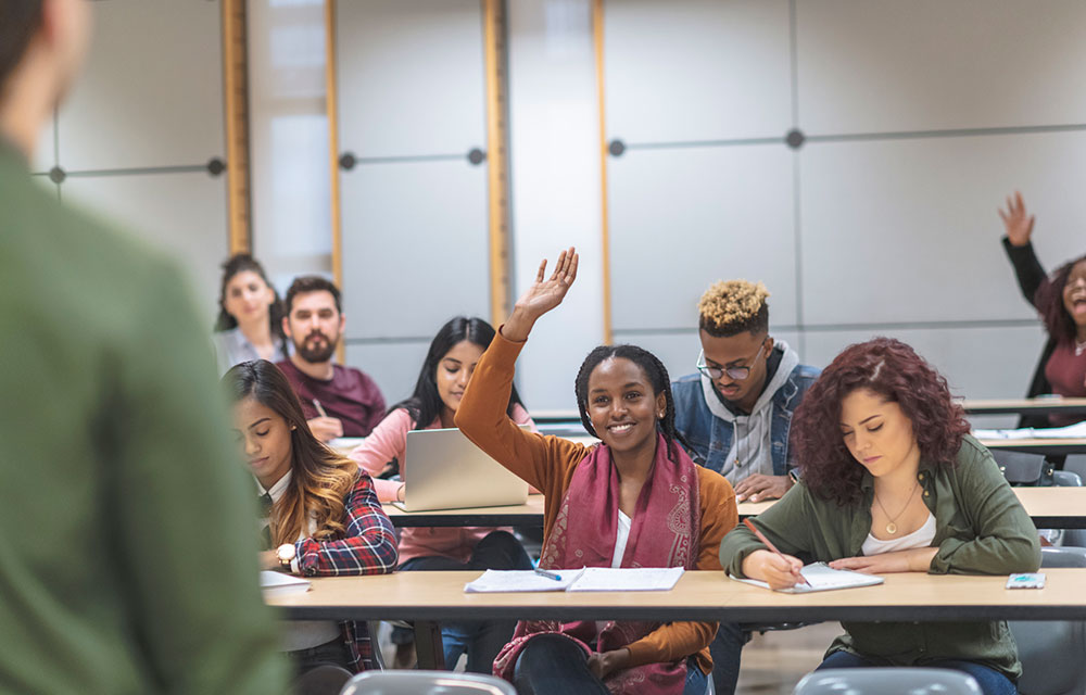 Kids raising their hands in class