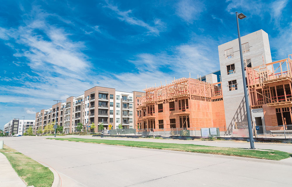 Row of apartment complexes with new units under constructed.