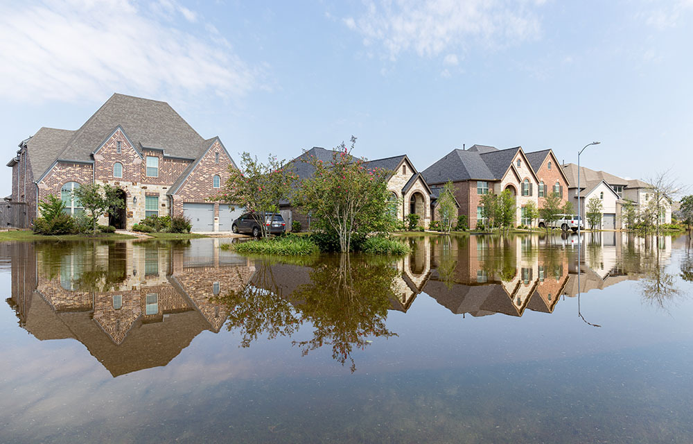 Flooded street in a suburban neighborhood.
