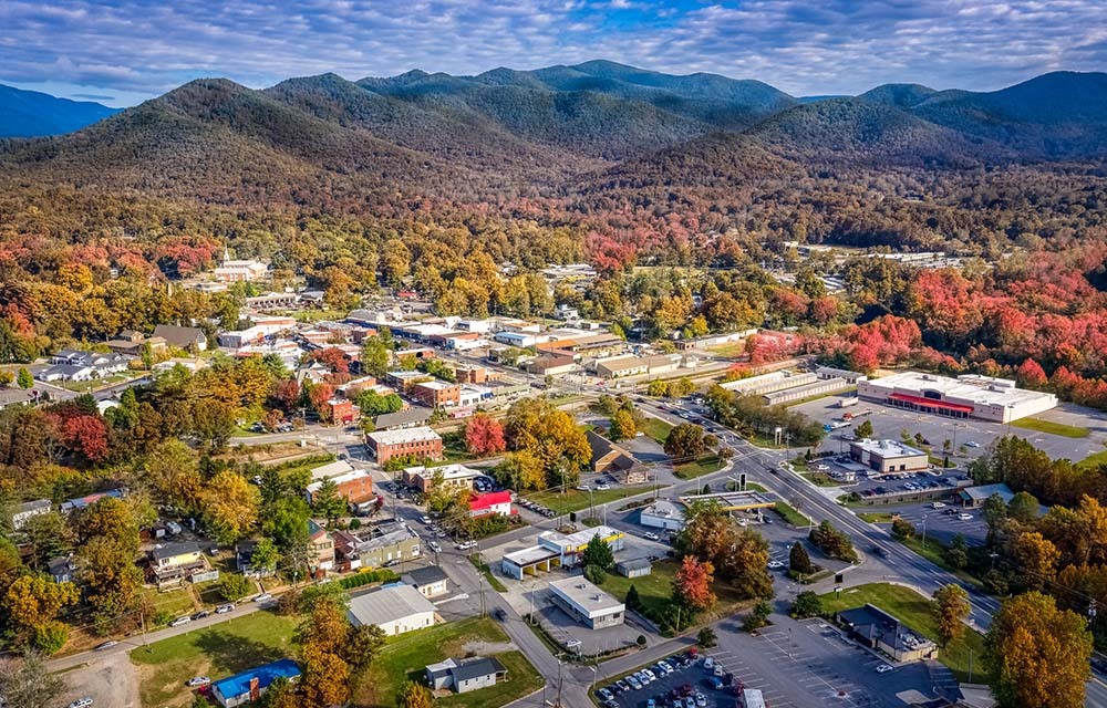 aerial view of a rural town in a valley with mountains in the background