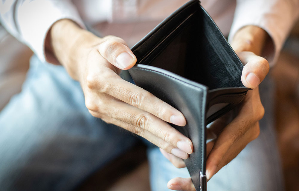 man opening his empty wallet