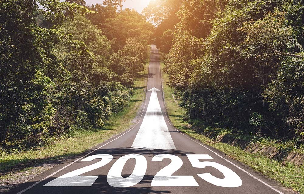 A long road with 2025 and an arrow pointing forward painted on top.