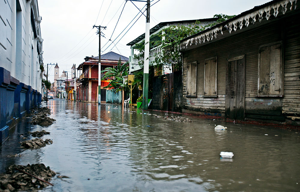 Residential street with standing water that has been flooded.