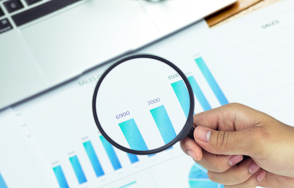 a graph and magnifying glass
