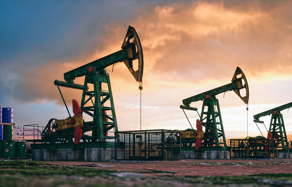 Working oil pumps against a cloud evening sky.