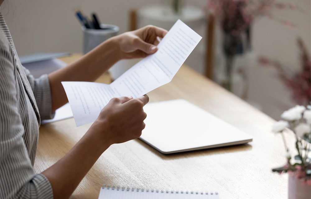 Close up young woman holding her letter of recommendation.