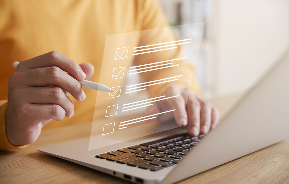 A person using a laptop to sign up for an online survey