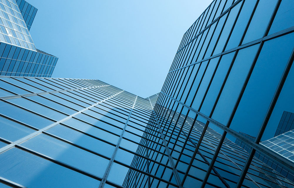 Angle view upward of a modern building with a clear blue sky in the background