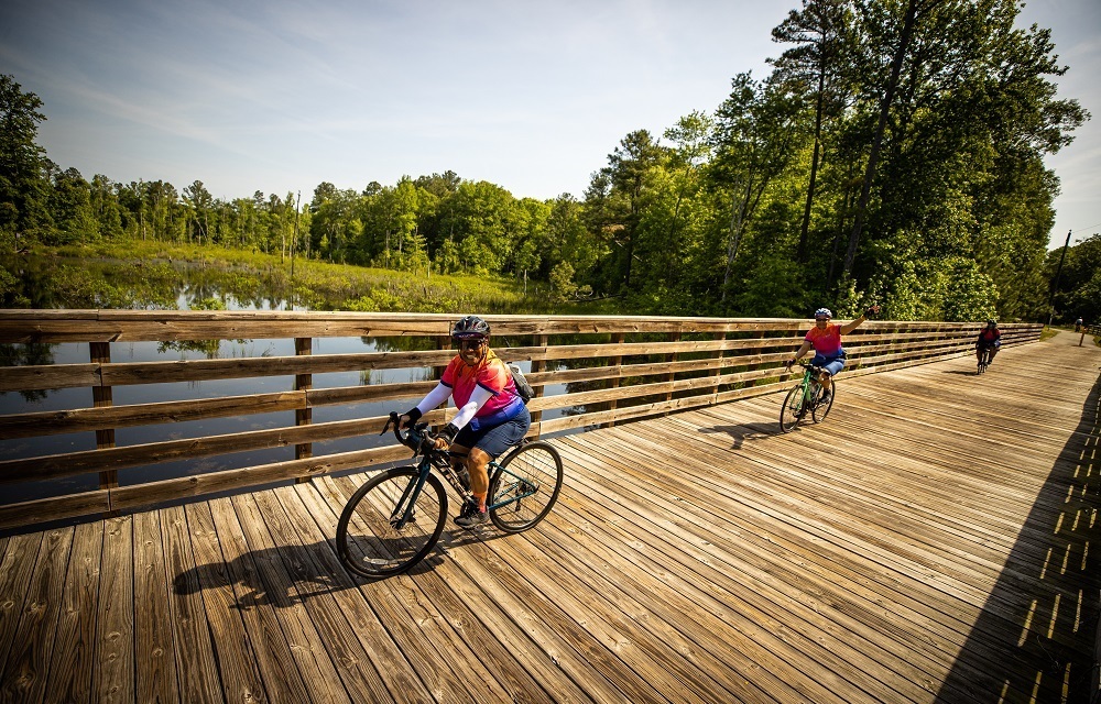 people riding bicycles on a deck