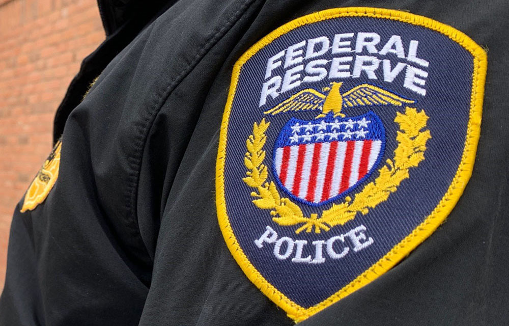 Close-up of a Federal Reserve Police badge on the arm of an officer