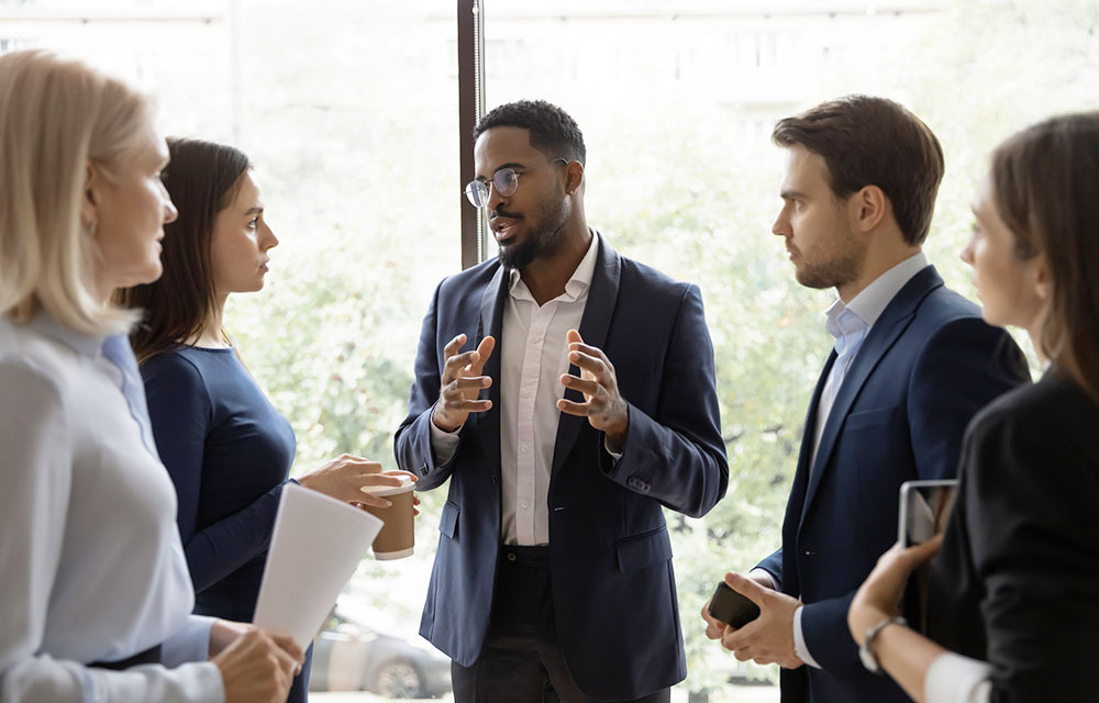 Male leader talking to colleagues