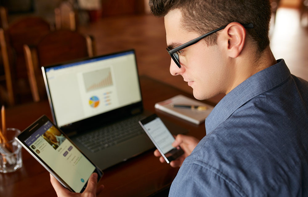 Man working on multiple devices at once.