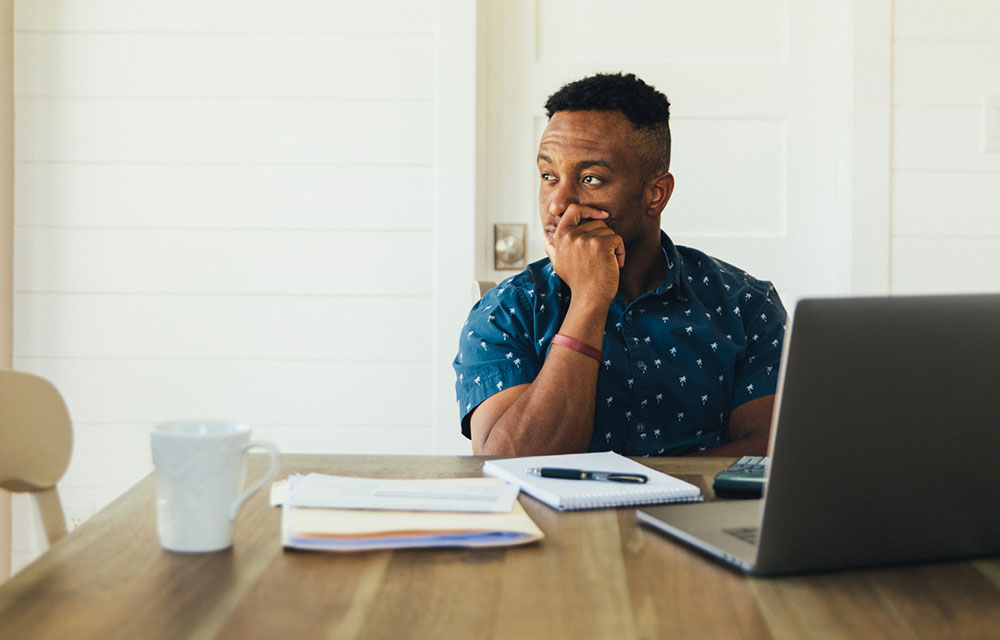 Pensive man over a computer