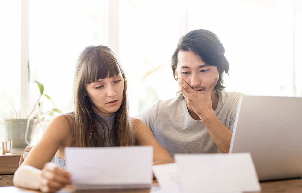 two people reviewing financial documents