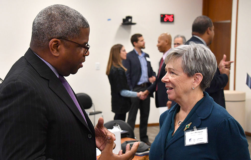 man talking to a woman at a conference