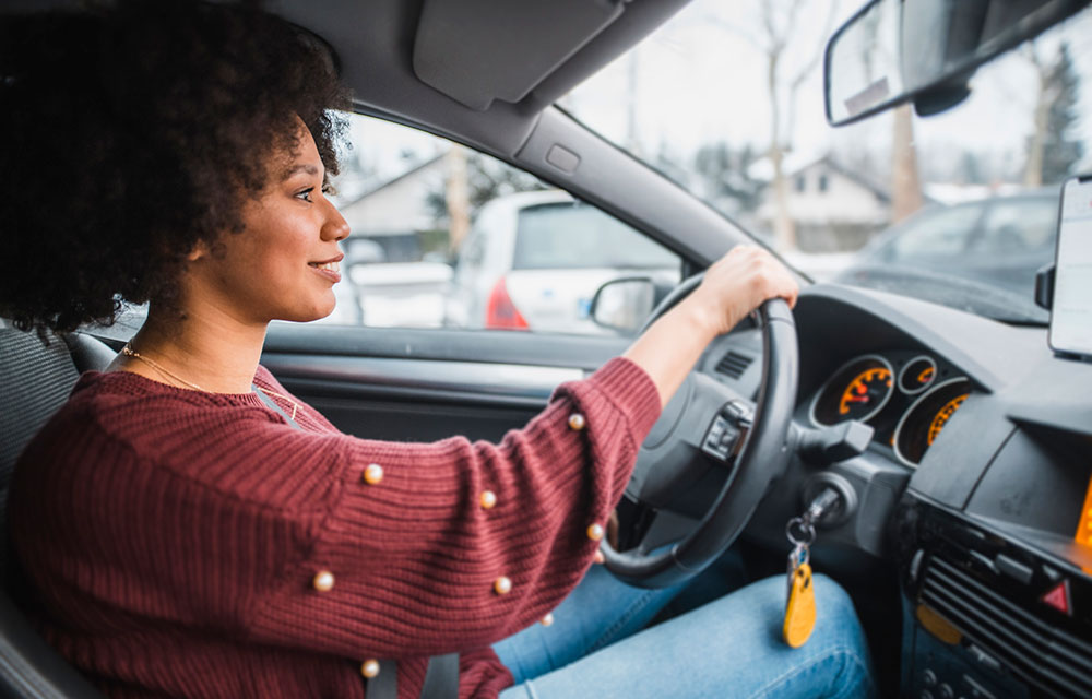 photo of a woman driving a car