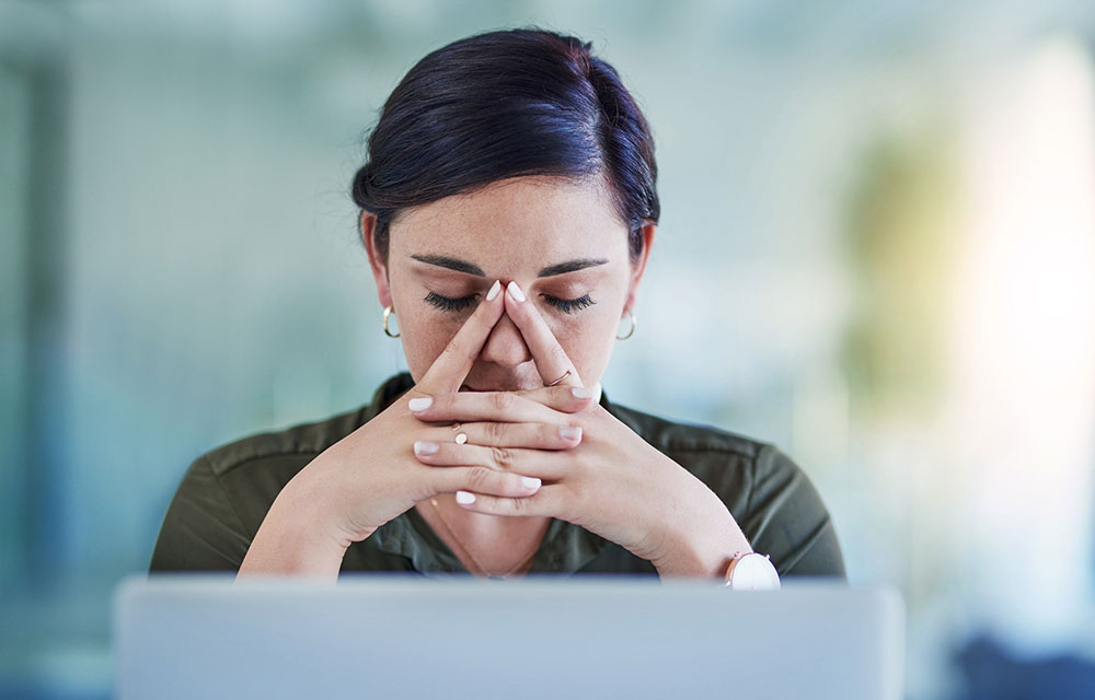 woman with folded hands and closed eyes