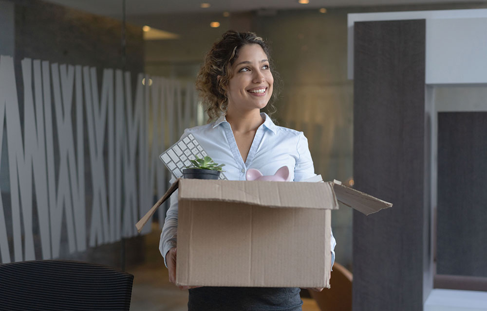 woman with box of belongings leaving a job