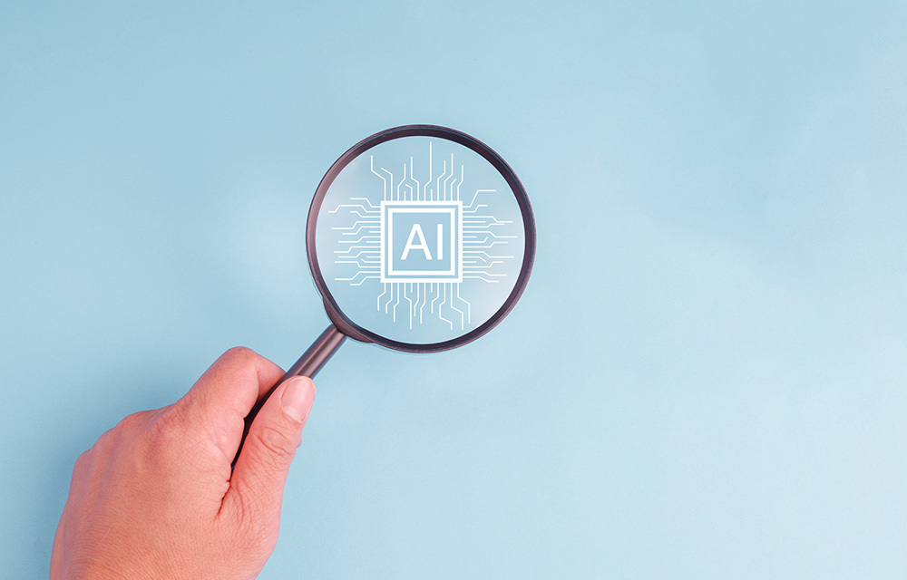 A hand holding a magnifying glass over a pastel blue background with the word AI on chip.