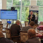 Attendees watch a presenter at an Investment Connection Pitch Session