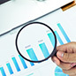 a graph and magnifying glass