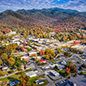 aerial view of a rural town in a valley with mountains in the background