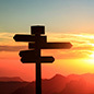 signs silhouetted against the sunset
